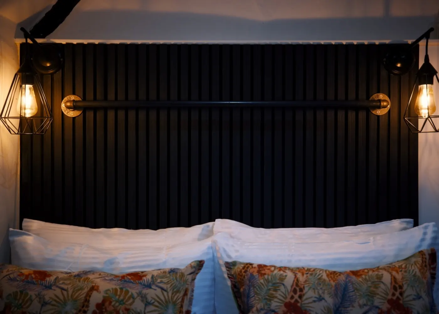 Double Bedroom with dark panelled headboard and pendant lights